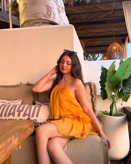 Adela Halterneck Ruffle Mini Dress - seated shot, marigold orange - Miss Mosa By Akanksha
