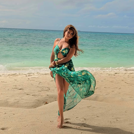 Aspen Swimsuit With Sarong Skirt In Dark Green - full-length shot on model on beach - Miss Mosa By Akanksha