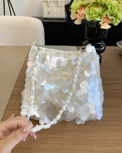 Belle Sequin Hand Bag With Chain - front shot held in hand, white iridescent paillette sequins with shell and pearl strap - Miss Mosa By Akanksha