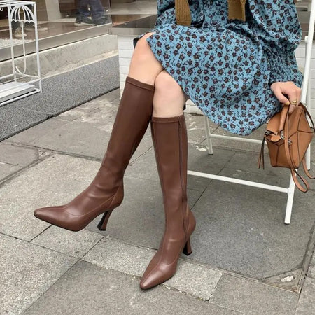 Blythe Pointed Leather Boots - seated side shot on model, brown - Miss Mosa By Akanksha