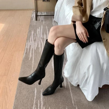 Blythe Pointed Leather Boots - seated front shot on model, black - Miss Mosa By Akanksha
