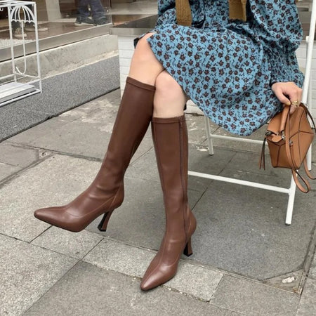 Blythe Pointed Leather Boots - seated side shot on model, brown - Miss Mosa By Akanksha