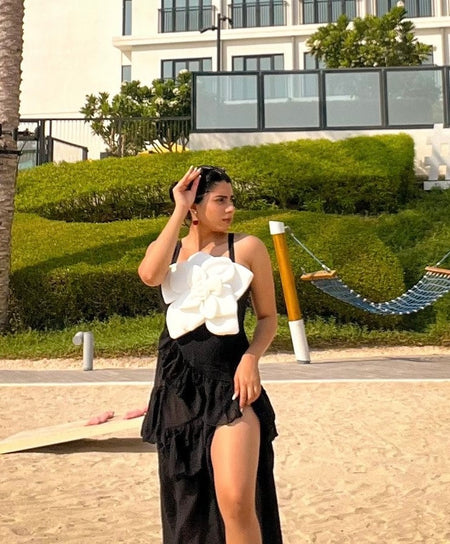 Camellia Rosette Swimsuit with Ruffled Skirt - lifestyle shot on model, black - Miss Mosa By Akanksha