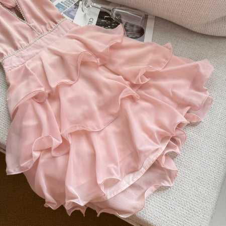 Carys Halterneck Pearl Ruffle Mini Dress - close-up detail shot of the tiered ruffle skirt, pink - Miss Mosa By Akanksha