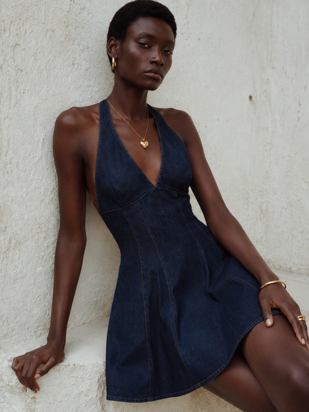 Coline Halterneck Mini Dress - seated three-quarter shot, dark indigo denim blue - Miss Mosa By Akanksha