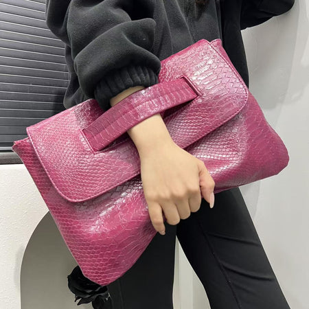 Cruz Textured PU Clutch Bag With Belt - handheld shot on model, pink - Miss Mosa By Akanksha