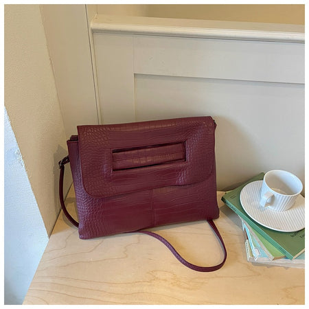 Cruz Textured PU Clutch Bag With Belt - styled product shot with strap, burgundy - Miss Mosa By Akanksha