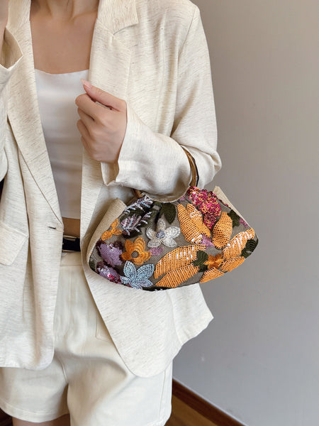 Dabel Embroidered Hand Bag - held shot on model, beige with orange and multicoloured floral sequins - Miss Mosa By Akanksha