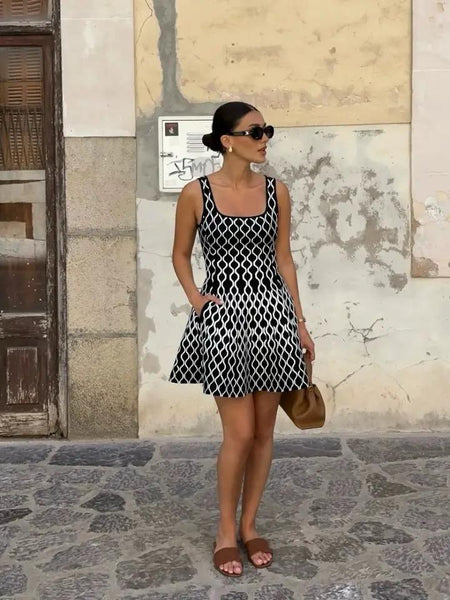 Elegant Luxe Short Knit Dress - front shot on model outdoors, black and white - Miss Mosa By Akanksha