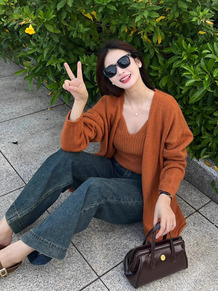 Elena Statement Woolen Tops with Cape Style Sweater - seated styling shot on model outdoors, rust - Miss Mosa By Akanksha