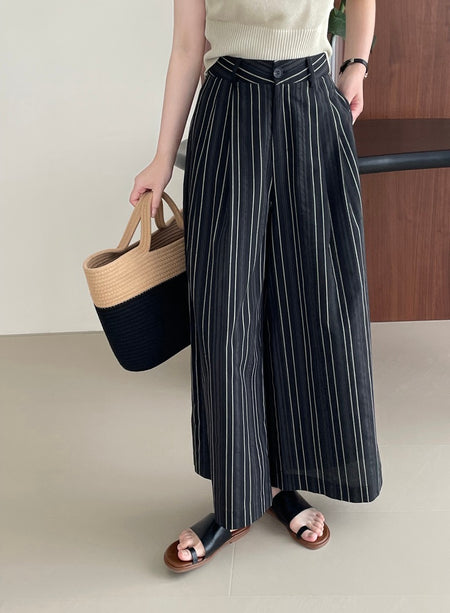 Elon Statement Striped Pants In Black - front shot on model holding bag - Miss Mosa By Akanksha