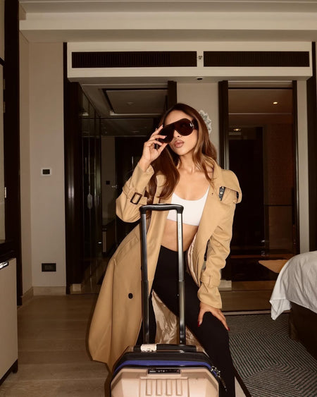Essie Statement Premium Trenchcoat - styling shot on model with luggage, beige - Miss Mosa By Akanksha