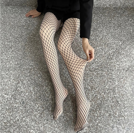 Fishnet Fleece Lined Stockings - Limited Edition - styling shot of legs on model, black - Miss Mosa By Akanksha