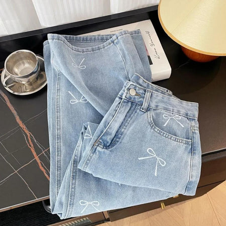 Gabi Bow Printed Denim Jeans In Blue - folded flat-lay product shot of the bow-printed jeans - Miss Mosa By Akanksha