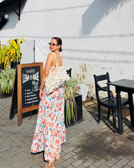Gemmo Breezy Summer Holiday Dress - three-quarter back shot on model, white with orange and blue floral print - Miss Mosa By Akanksha
