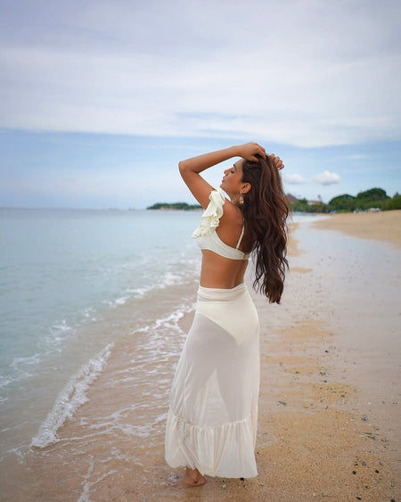 Hannah Swimsuit with Sarong Skirt - side shot on model on beach, cream - Miss Mosa By Akanksha