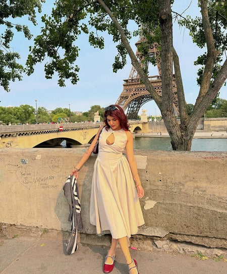 Harlow Statement Dropwaist Midi Dress - front shot on model by a bridge, cream - Miss Mosa By Akanksha