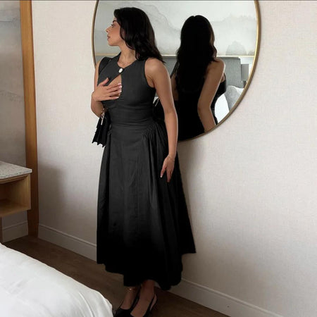 Harlow Statement Dropwaist Midi Dress - side shot on model by a round mirror, black - Miss Mosa By Akanksha