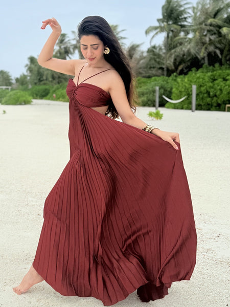 Hay Luxe Pleated Flowy Maxi Dress In Maroon - full-length front shot on model swirling the skirt on the beach - Miss Mosa By Akanksha