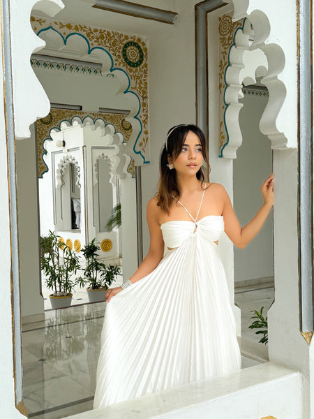 Hay Luxe Pleated Flowy Maxi Dress In White - full-length front shot on model in an arched doorway - Miss Mosa By Akanksha