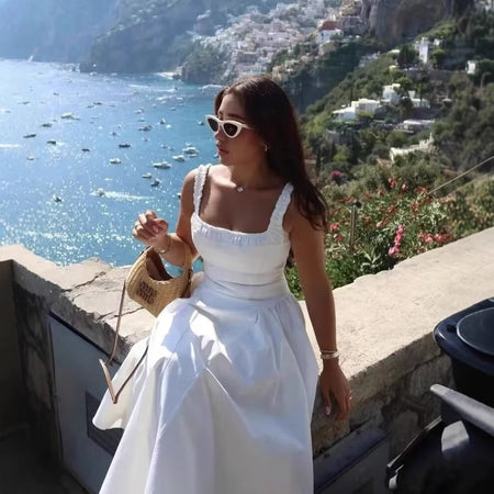 Hela Summer Dropwaist Holiday Dress In White - front shot on model seated - Miss Mosa By Akanksha