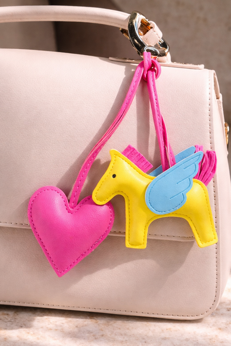 Horse and Heart Set of 2 Bag Charms - lifestyle shot of charms on a beige bag, pink and yellow - Miss Mosa By Akanksha