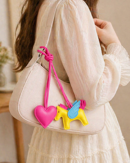 Horse and Heart Set of 2 Bag Charms - lifestyle shot of charms on beige shoulder bag, pink and yellow - Miss Mosa By Akanksha