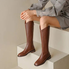 Jonas Knee High Premium Leather Boots - front shot on model seated, brown - Miss Mosa By Akanksha