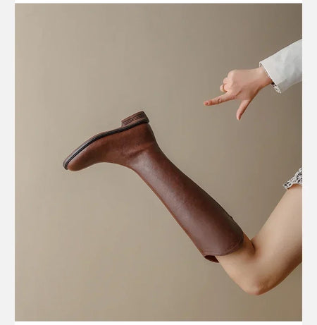 Jonas Knee High Premium Leather Boots - styling shot of single boot on model, brown - Miss Mosa By Akanksha