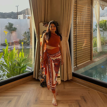 Kairo Luxe Swimsuit with Sarong Skirt In Rust - lifestyle shot on model, rust - Miss Mosa By Akanksha