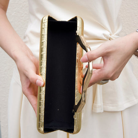 Leif Hand Bag With Chain - interior shot held open on model, gold - Miss Mosa By Akanksha