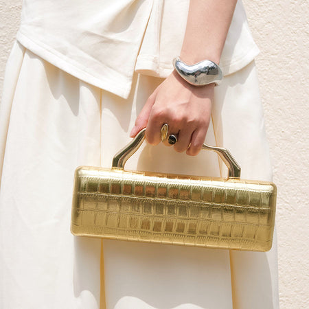 Leif Hand Bag With Chain - top-handle carry shot on model, gold - Miss Mosa By Akanksha