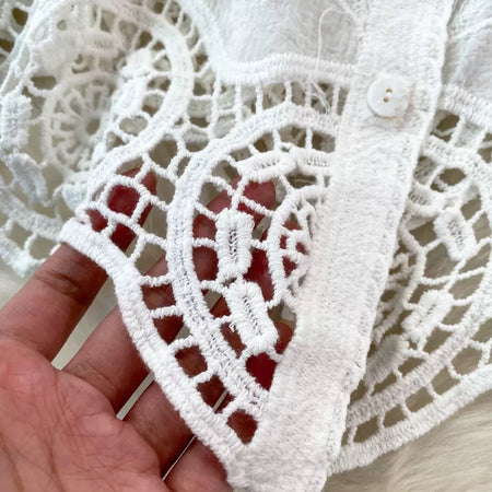 Levy Embroidered Cotton Shirt - close-up of the crochet hem lace detail held in hand, white - Miss Mosa By Akanksha