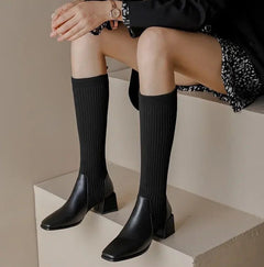 Lia Knee High Trendy Sock Leather Boots - front shot on model seated, black - Miss Mosa By Akanksha