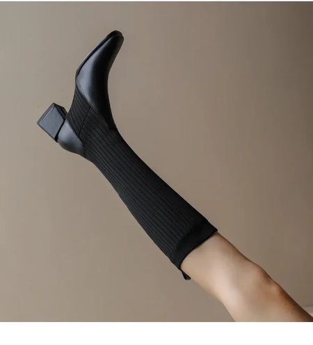 Lia Knee High Trendy Sock Leather Boots - close-up of boot heel on model, black - Miss Mosa By Akanksha