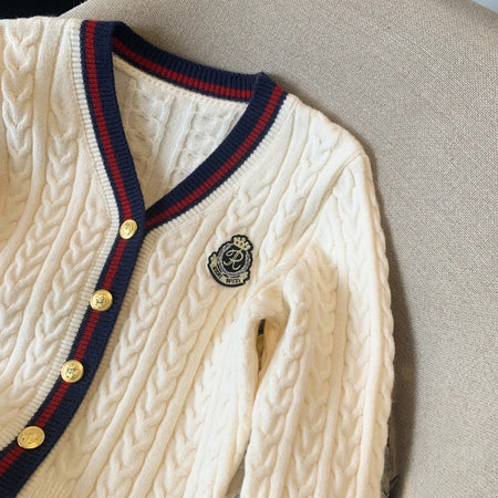 Luisa Woolen Cardigan In Off White - close-up shot of neckline and crest badge - Miss Mosa By Akanksha
