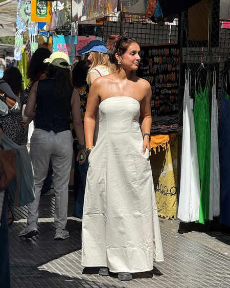 Maisie Offshoulder Holiday Tube Dress In Beige - full-length back shot on model at a market - Miss Mosa By Akanksha