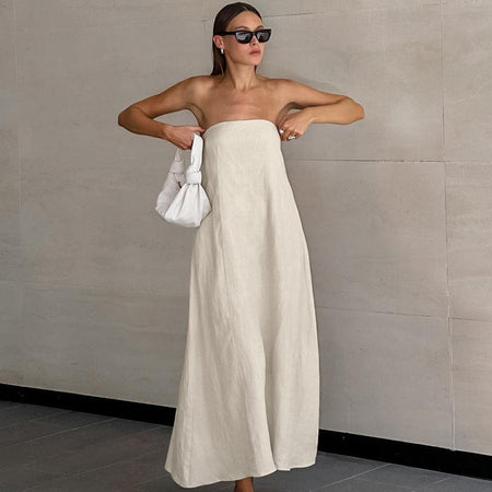 Maisie Offshoulder Holiday Tube Dress In Beige - full-length front shot on model holding a bag - Miss Mosa By Akanksha