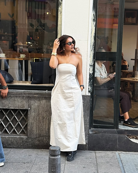 Maisie Offshoulder Holiday Tube Dress In Beige - full-length front shot on model at a cafe - Miss Mosa By Akanksha