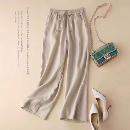 Manon Statement Linen Pants In Beige - flat-lay product shot with bag and heels - Miss Mosa By Akanksha