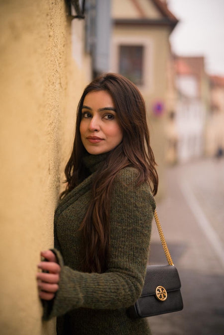 Micola Woolen Dress With Scarf In Olive - close-up shot on model leaning on wall - Miss Mosa By Akanksha