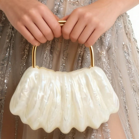 Mimi Hand Bag With Chain - close-up shot of bag held by model, pearl white with gold handle - Miss Mosa By Akanksha