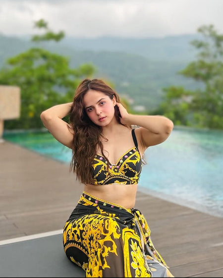 Morocco Swimsuit With Sarong Skirt In Black - seated front shot on model poolside - Miss Mosa By Akanksha