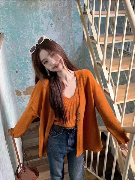 Nixie Statement Woolen Tops with Cape Style Sweater - front shot on model on stairs, rust - Miss Mosa By Akanksha
