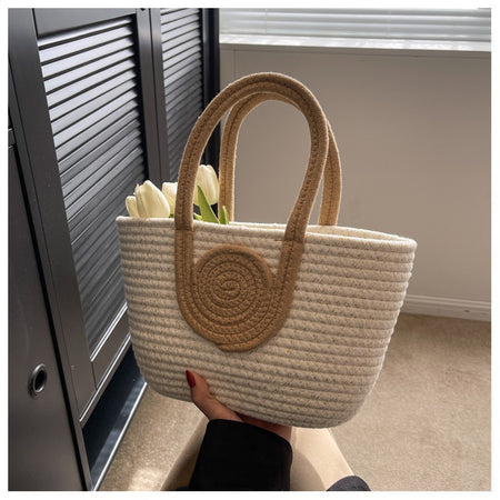 Orin Crochet Hand Bag - front shot held in hand, cream woven cotton with tan handles - Miss Mosa By Akanksha