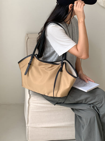 Remi Tote Bag - seated shoulder-carry shot on model, tan - Miss Mosa By Akanksha