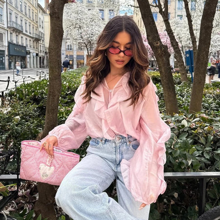 Saga Ruffled Top In Pink - seated front shot on model outdoors - Miss Mosa By Akanksha