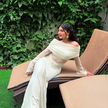 Saya Luxe Bodycon Maxi Dress - side shot on model seated outdoors, cream - Miss Mosa By Akanksha