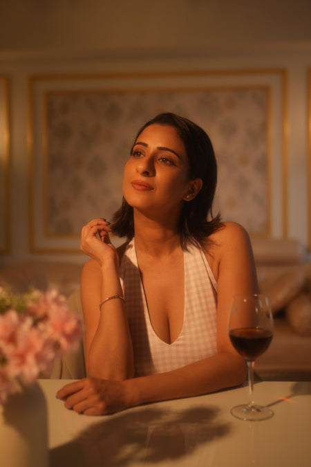Shireen Drop Waist Midi Dress In Pink - close-up shot on model seated at a table - Miss Mosa By Akanksha