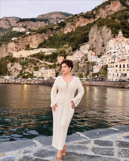 Shirly Luxe Crochet Knit Dress -Resortwear In Beige - front shot on model on harbour walkway - Miss Mosa By Akanksha